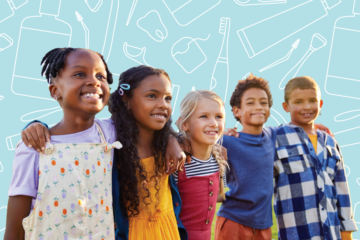 Group of school-aged children standing in front of dental health icons